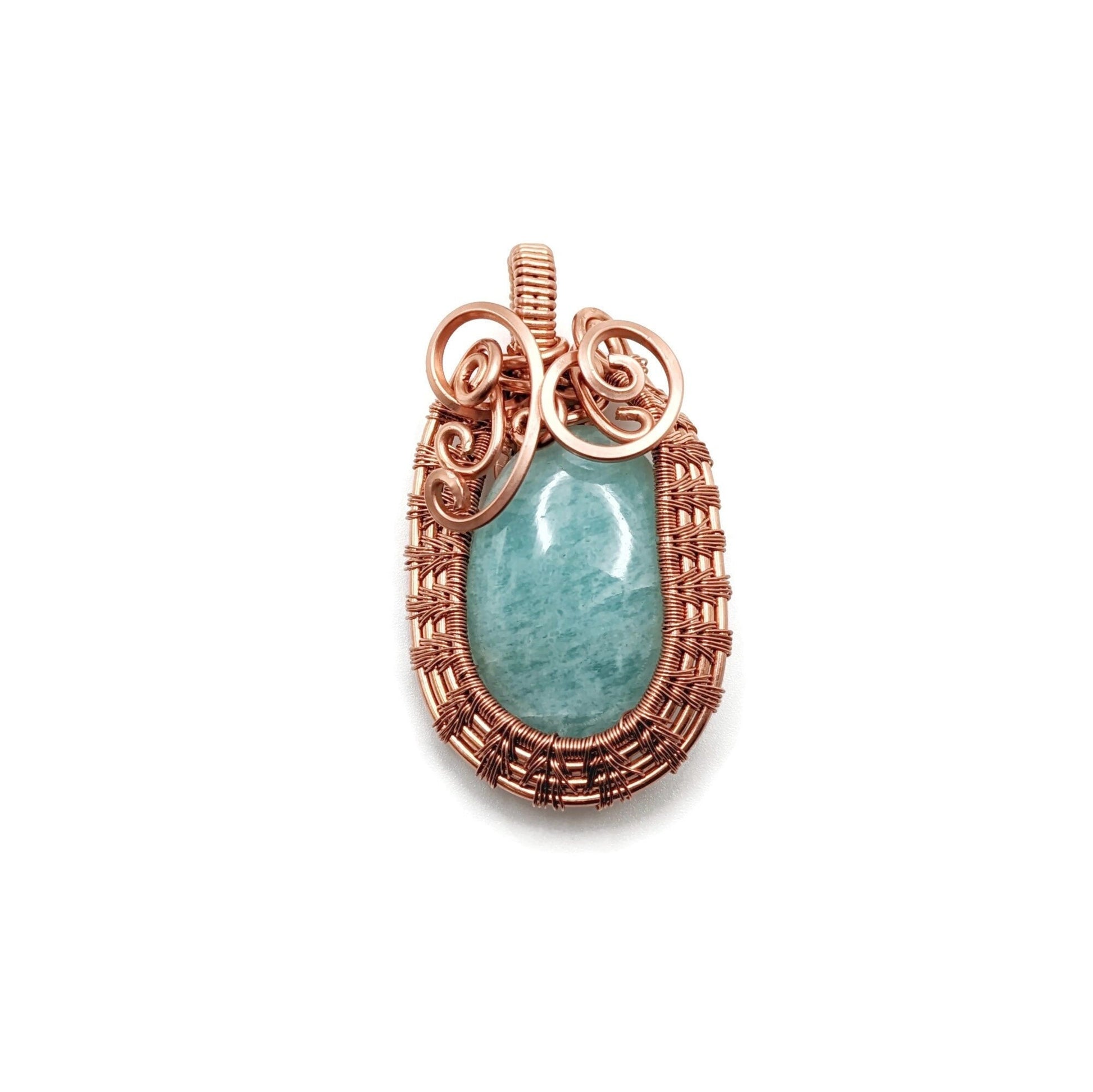 Bright blue Amazonite set in 99.9% copper with an Egyptian-like weave around it.