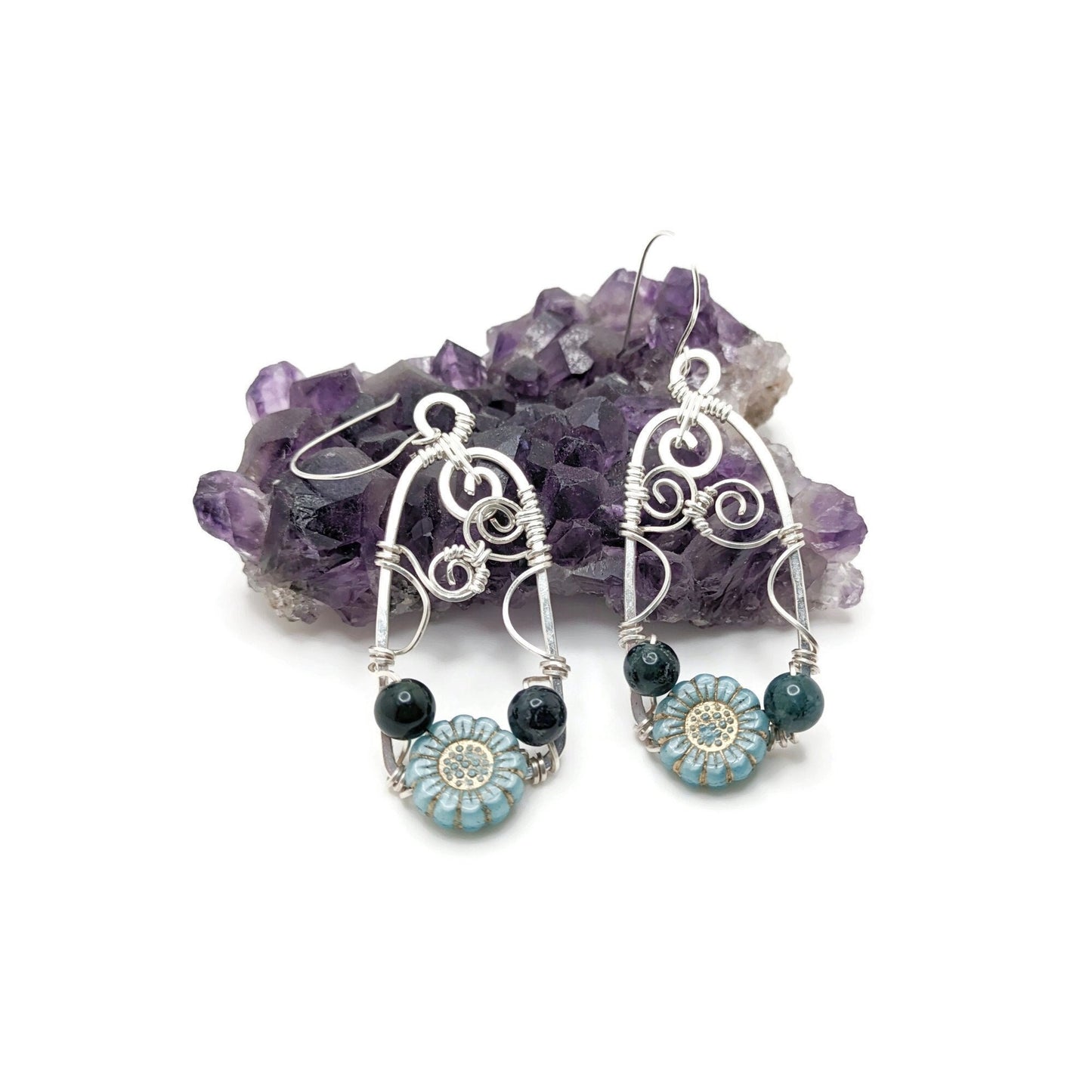 Silver doorway earrings with light blue wildflower and blue beads.